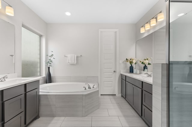 29622 Sterling Knoll Dr, Fulshear, TX 77441 - bathroom with two vanities, a garden tub, and recessed lighting
