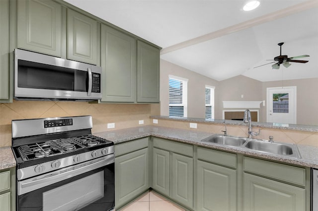 10143 Rose Willow Ln, Brookshire, TX 77423 - kitchen with stainless steel appliances, green cabinetry, ceiling fan, lofted ceiling, and tasteful backsplash