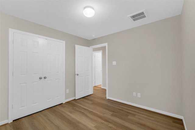 10143 Rose Willow Ln, Brookshire, TX 77423 - unfurnished bedroom featuring wood finished floors and a closet