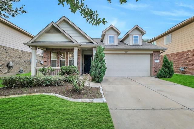 10143 Rose Willow Ln, Brookshire, TX 77423 - view of front of property with brick siding, a garage, covered porch, a front lawn, and driveway