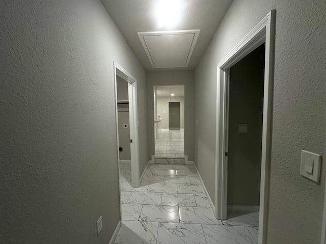 9013 Lugary Dr, Houston, TX 77074 - hallway with attic access, light marble finish flooring, and a textured wall