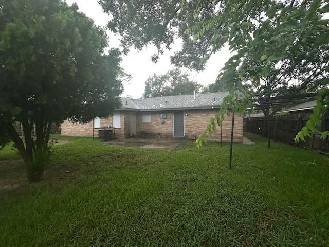 9013 Lugary Dr, Houston, TX 77074 - back of property with a patio area