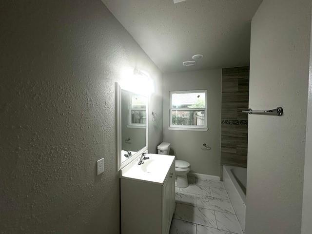 9013 Lugary Dr, Houston, TX 77074 - full bathroom featuring vanity, marble finish flooring, and lofted ceiling