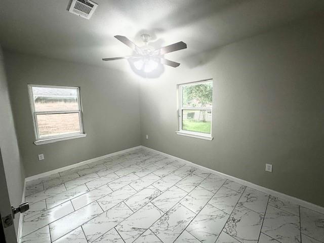 9013 Lugary Dr, Houston, TX 77074 - empty room with marble look tile flooring and ceiling fan