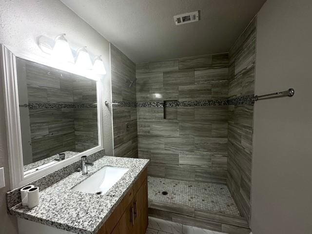 9013 Lugary Dr, Houston, TX 77074 - bathroom featuring vanity and a tile shower