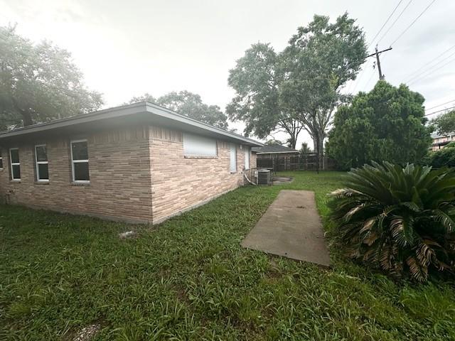 9013 Lugary Dr, Houston, TX 77074 - view of side of property featuring brick siding and a patio