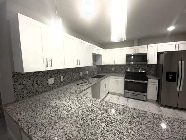 9013 Lugary Dr, Houston, TX 77074 - kitchen with stainless steel appliances, light stone countertops, white cabinetry, tasteful backsplash, and light marble finish flooring