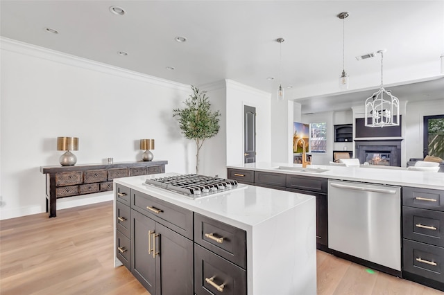 5406 Darling St Unit A, Houston, TX 77007 - kitchen featuring stainless steel appliances, light countertops, open floor plan, light wood finished floors, and a kitchen island