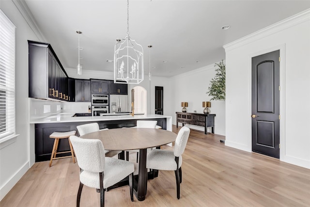 5406 Darling St Unit A, Houston, TX 77007 - dining area with plenty of natural light, crown molding, light wood-style flooring, and a chandelier