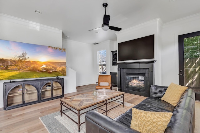5406 Darling St Unit A, Houston, TX 77007 - living area with a glass covered fireplace, ornamental molding, wood finished floors, ceiling fan, and recessed lighting