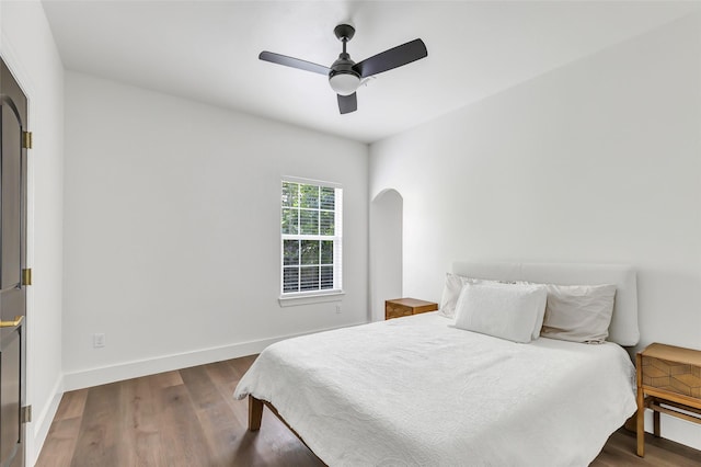 5406 Darling St Unit A, Houston, TX 77007 - bedroom featuring arched walkways, dark wood-type flooring, and ceiling fan
