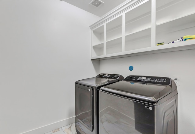 5406 Darling St Unit A, Houston, TX 77007 - washroom with light marble finish flooring and washing machine and clothes dryer