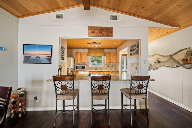 374 W Lake Shore Dr, Livingston, TX 77351 - kitchen featuring dark wood-style floors, stainless steel microwave, wood ceiling, a peninsula, and backsplash