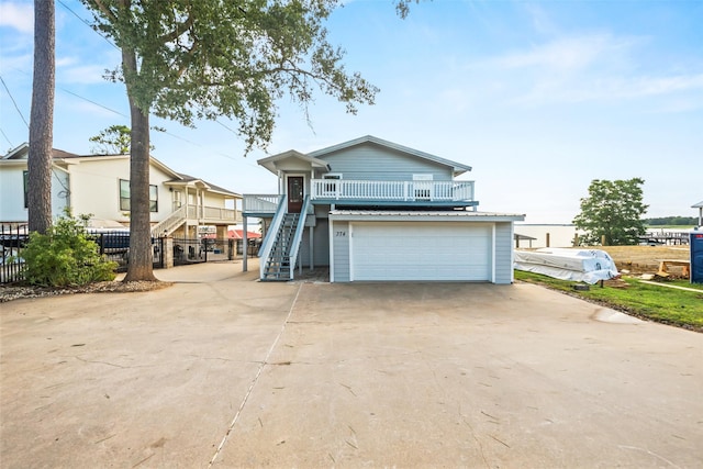 374 W Lake Shore Dr, Livingston, TX 77351 - view of front facade featuring an attached garage, stairs, and concrete driveway