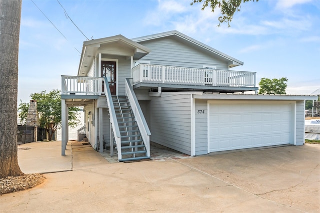 374 W Lake Shore Dr, Livingston, TX 77351 - view of front facade with a garage, driveway, stairway, and a deck
