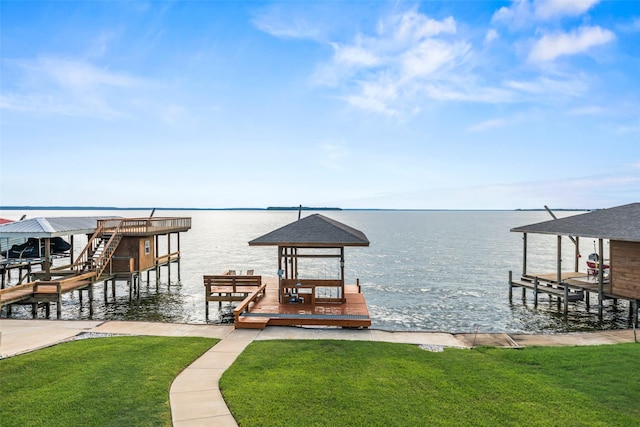 374 W Lake Shore Dr, Livingston, TX 77351 - dock area featuring boat lift, a water view, and a lawn