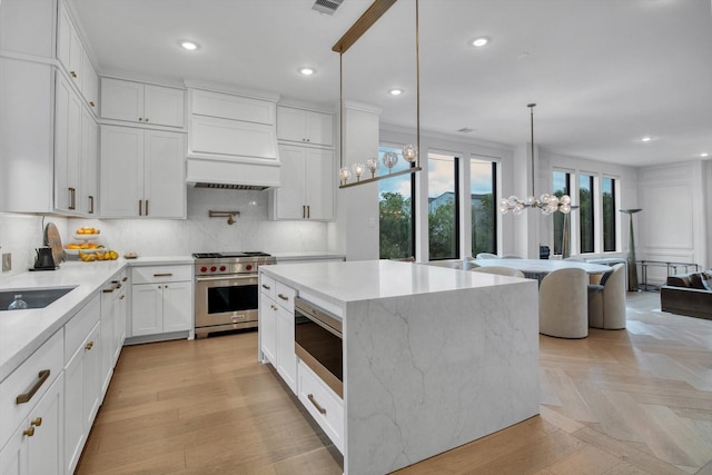 3502 Dorset Cliff Ln, Houston, TX 77055 - kitchen featuring appliances with stainless steel finishes, custom range hood, a chandelier, recessed lighting, and decorative backsplash