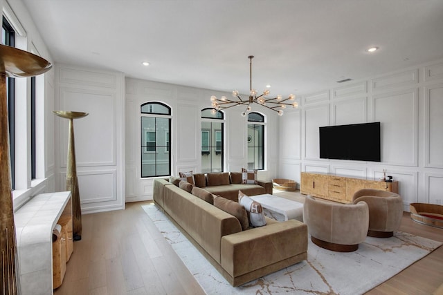 3502 Dorset Cliff Ln, Houston, TX 77055 - living area featuring a decorative wall, a chandelier, light wood-style flooring, recessed lighting, and plenty of natural light