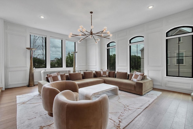 3502 Dorset Cliff Ln, Houston, TX 77055 - living area featuring a decorative wall, a chandelier, plenty of natural light, light wood-type flooring, and recessed lighting