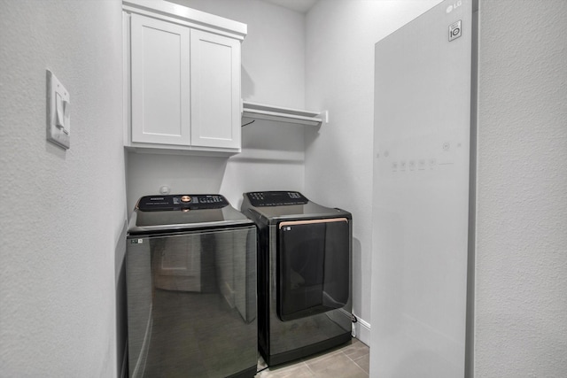 3502 Dorset Cliff Ln, Houston, TX 77055 - laundry area with cabinet space, washer and clothes dryer, and light tile patterned flooring