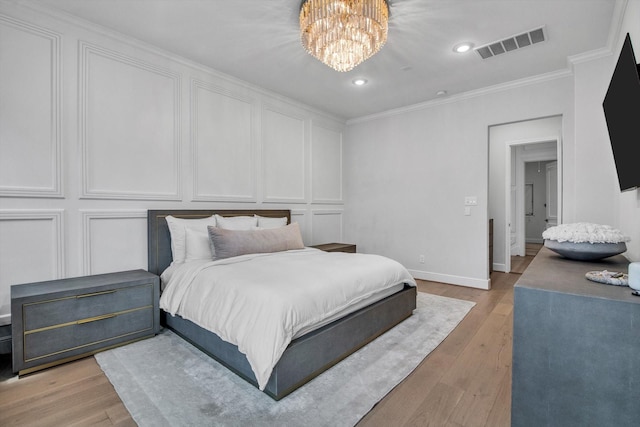 3502 Dorset Cliff Ln, Houston, TX 77055 - bedroom featuring a chandelier, ornamental molding, light wood-style flooring, recessed lighting, and a decorative wall