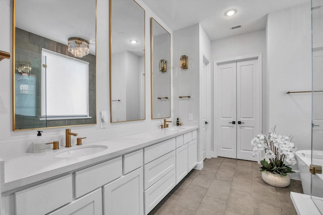 3502 Dorset Cliff Ln, Houston, TX 77055 - full bath with double vanity, a freestanding tub, tile patterned floors, and recessed lighting