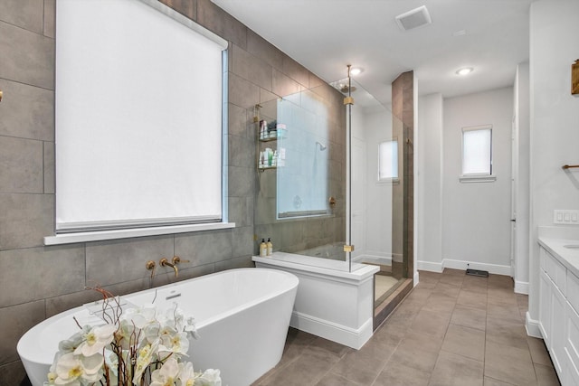 3502 Dorset Cliff Ln, Houston, TX 77055 - bathroom with a stall shower, vanity, a freestanding tub, and tile patterned flooring