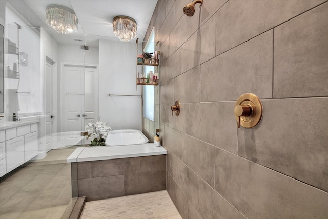 3502 Dorset Cliff Ln, Houston, TX 77055 - bathroom with a chandelier, tile patterned floors, a tile shower, and a bath