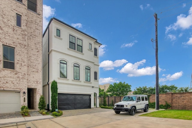 3502 Dorset Cliff Ln, Houston, TX 77055 - view of front of house with driveway, a garage, and stucco siding