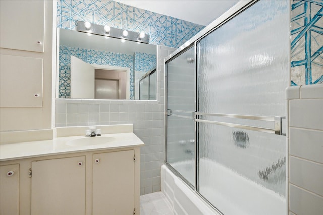 6249 Piping Rock Ln, Houston, TX 77057 - bathroom featuring tile walls, vanity, and enclosed tub / shower combo