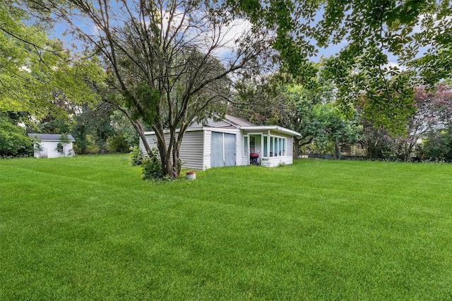 13922 Ambrose St, Houston, TX 77045 - view of green lawn featuring an outbuilding and view of scattered trees