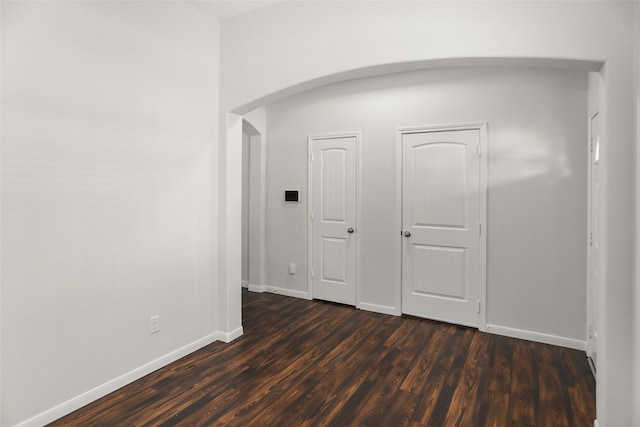 23753 Briar Tree Dr, Porter, TX 77365 - spare room with arched walkways and dark wood-style flooring