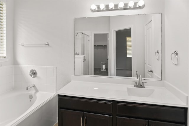 23753 Briar Tree Dr, Porter, TX 77365 - full bathroom featuring a garden tub, vanity, a spacious closet, and a shower with door
