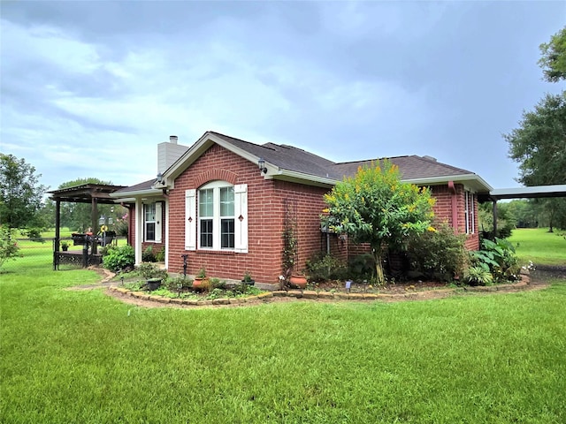 110 Red Bud St, Shepherd, TX 77371 - view of home's exterior featuring brick siding, a chimney, and roof with shingles