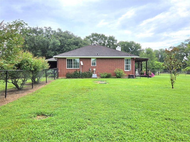 110 Red Bud St, Shepherd, TX 77371 - back of property with brick siding, a fenced backyard, a chimney, and a shingled roof