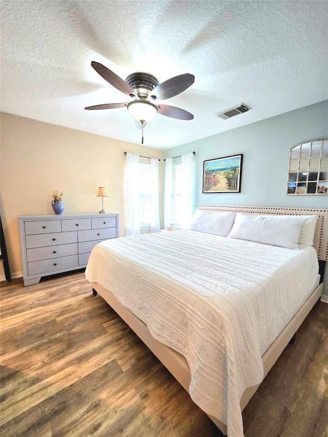 110 Red Bud St, Shepherd, TX 77371 - bedroom featuring a textured ceiling, wood finished floors, and ceiling fan