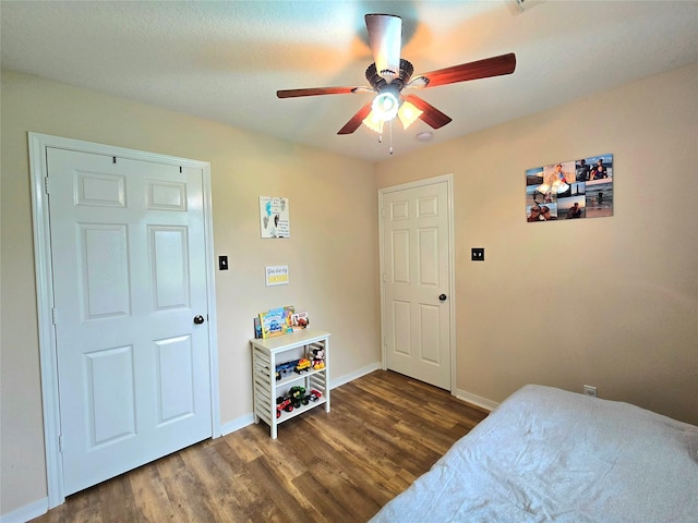 110 Red Bud St, Shepherd, TX 77371 - bedroom with dark wood-type flooring and ceiling fan