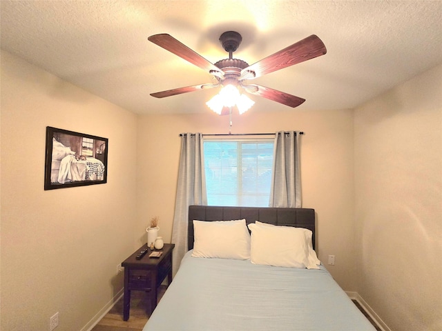 110 Red Bud St, Shepherd, TX 77371 - bedroom featuring a textured ceiling and a ceiling fan