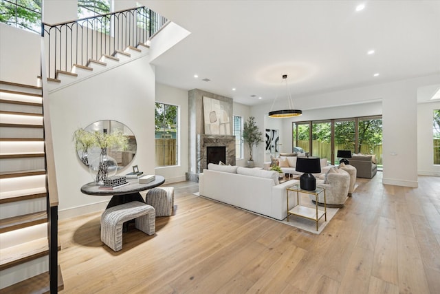 3755 Rice Blvd, Houston, TX 77005 - living area featuring light wood-type flooring, stairway, recessed lighting, and a stone fireplace