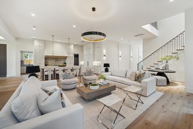 3755 Rice Blvd, Houston, TX 77005 - living area with light wood-style flooring, stairs, and recessed lighting