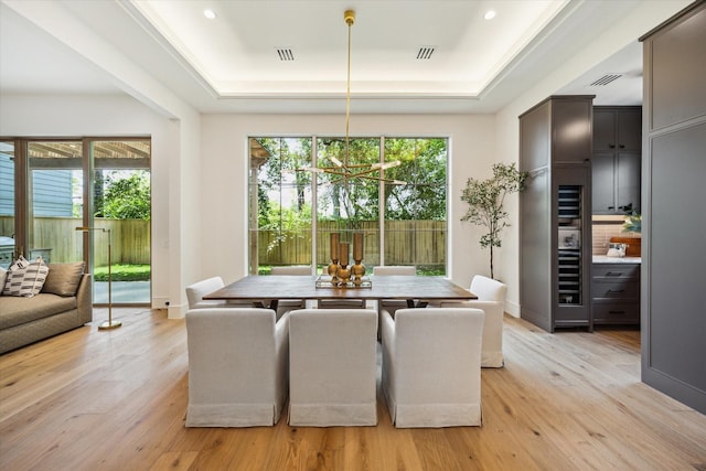 3755 Rice Blvd, Houston, TX 77005 - dining area with a raised ceiling, light wood-style flooring, a chandelier, and recessed lighting