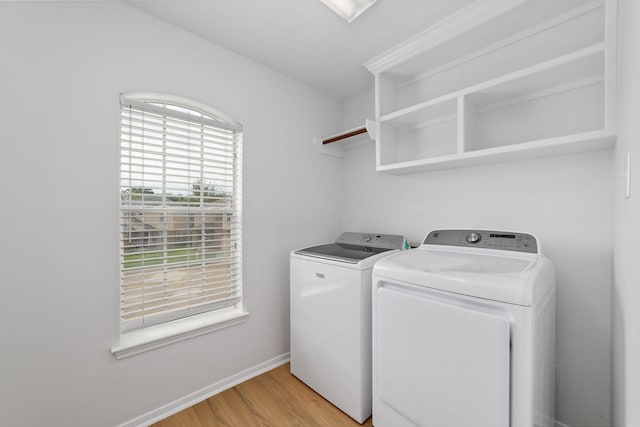 4444 Victory Dr Unit 26, Houston, TX 77088 - laundry area featuring washing machine and clothes dryer and light wood finished floors
