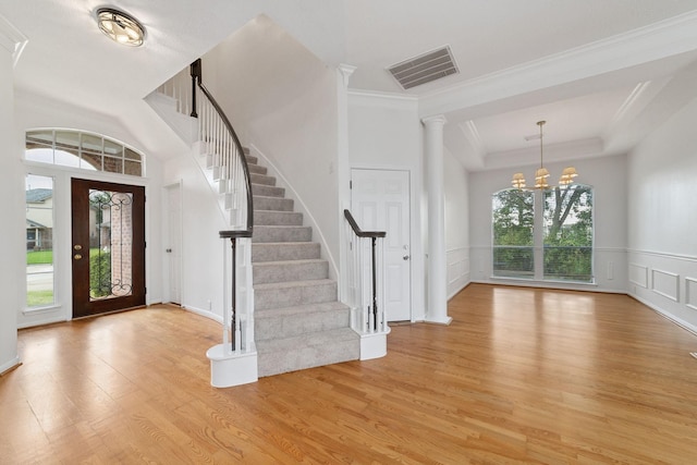 4444 Victory Dr Unit 26, Houston, TX 77088 - entryway featuring light wood-style flooring, stairs, ornamental molding, a chandelier, and a tray ceiling