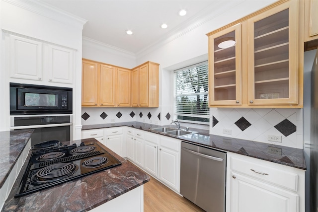 4444 Victory Dr Unit 26, Houston, TX 77088 - kitchen featuring black appliances, ornamental molding, glass insert cabinets, dark stone counters, and decorative backsplash