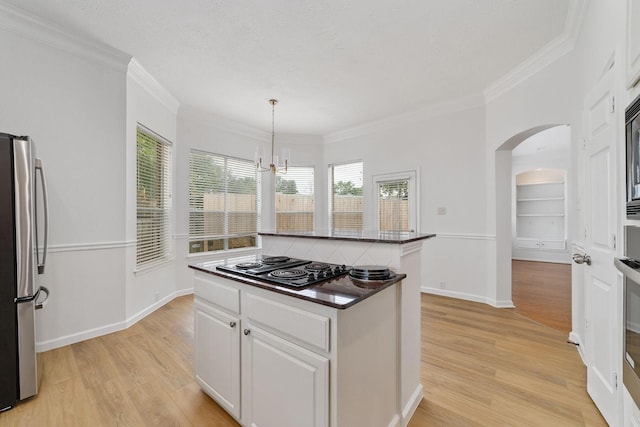 4444 Victory Dr Unit 26, Houston, TX 77088 - kitchen featuring freestanding refrigerator, black electric cooktop, dark countertops, a kitchen island, and light wood-type flooring