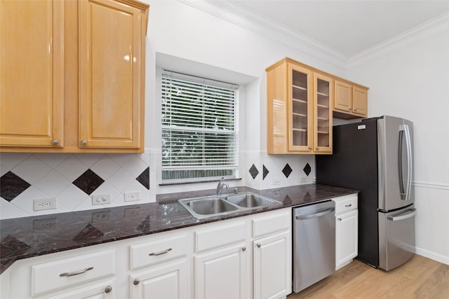 4444 Victory Dr Unit 26, Houston, TX 77088 - kitchen with stainless steel appliances, ornamental molding, glass insert cabinets, light wood-style flooring, and tasteful backsplash