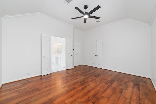4444 Victory Dr Unit 26, Houston, TX 77088 - unfurnished bedroom featuring vaulted ceiling, wood finished floors, ornamental molding, ensuite bath, and ceiling fan