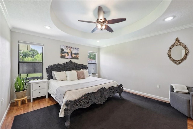 505 Shannons Way, Bridge City, TX 77611 - bedroom featuring crown molding, multiple windows, wood finished floors, recessed lighting, and a tray ceiling