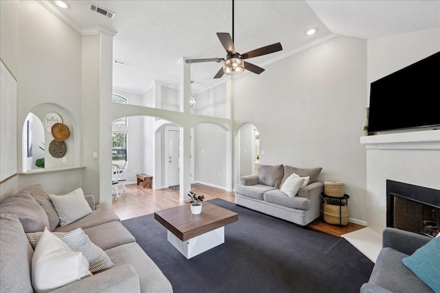 505 Shannons Way, Bridge City, TX 77611 - living room featuring arched walkways, wood finished floors, ceiling fan, high vaulted ceiling, and crown molding