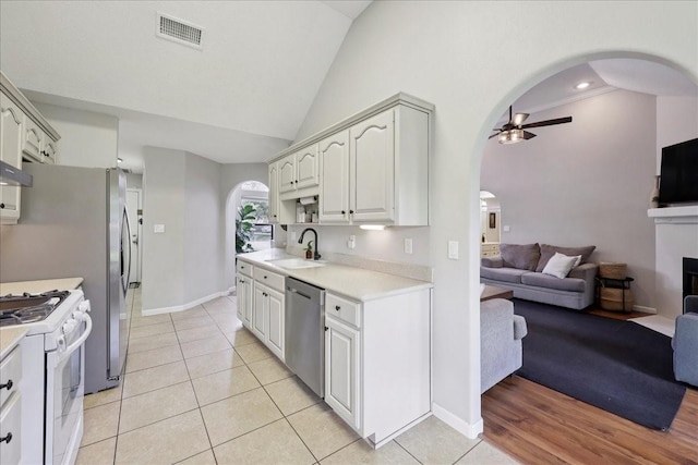 505 Shannons Way, Bridge City, TX 77611 - kitchen featuring arched walkways, stainless steel appliances, open floor plan, a ceiling fan, and lofted ceiling